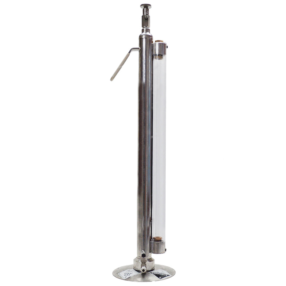 A tall, slender stainless steel sulphitometer with a circular base, a vertical transparent cylindrical chamber, and a small side handle, shown on a plain white background.