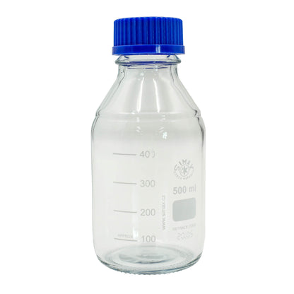 Clear glass bottle with blue cap on a white background