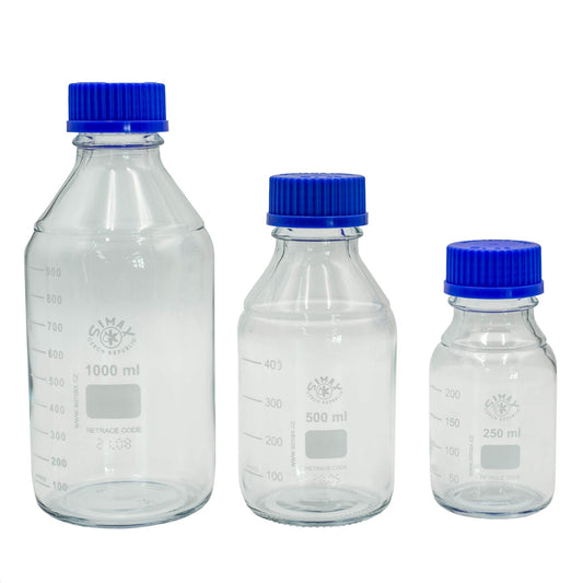 Three clear glass bottles with blue lids on a white background