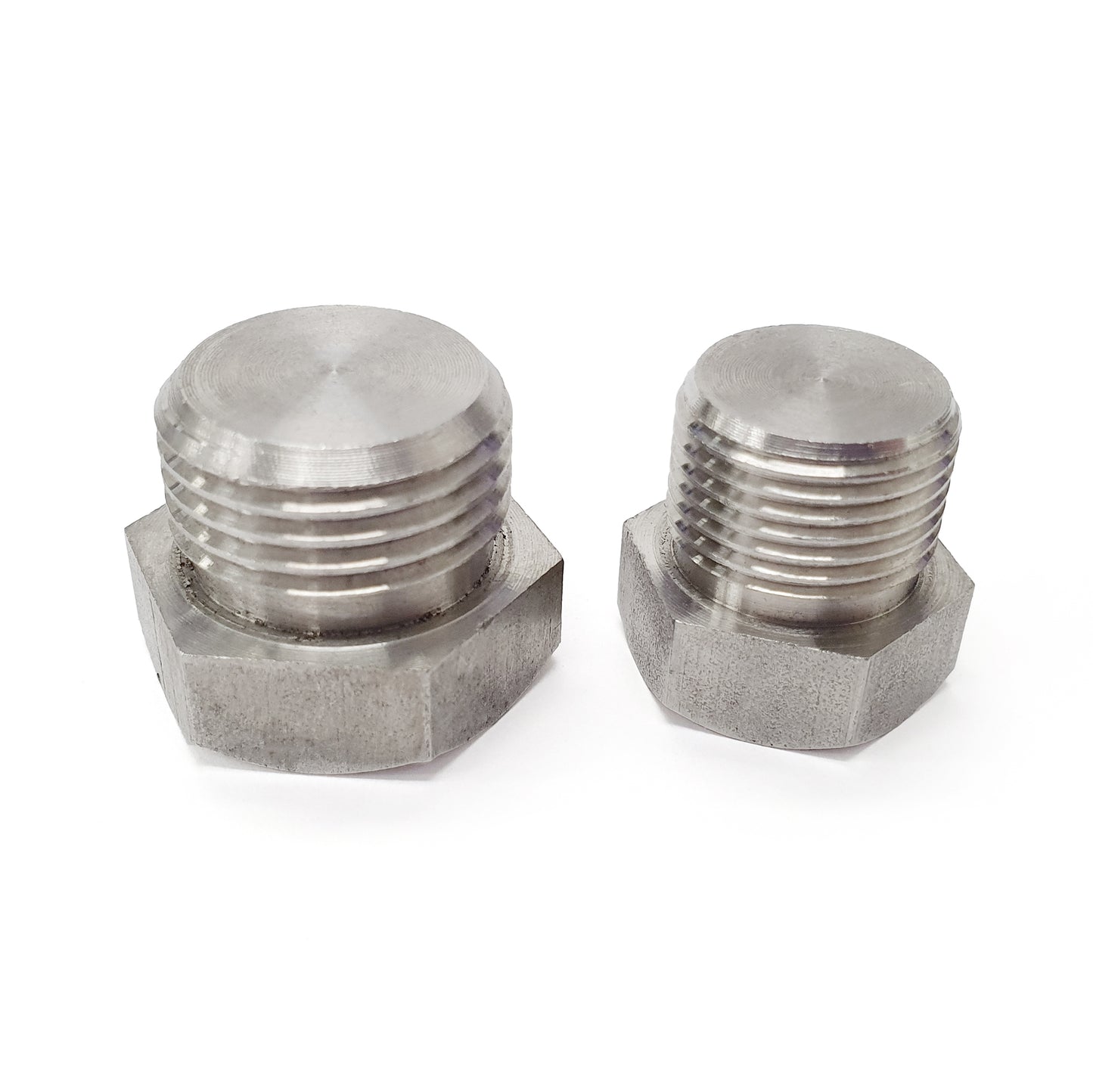 Two metal hex nuts on a white background