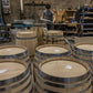 multiple wine barrels in a shed with silver rings