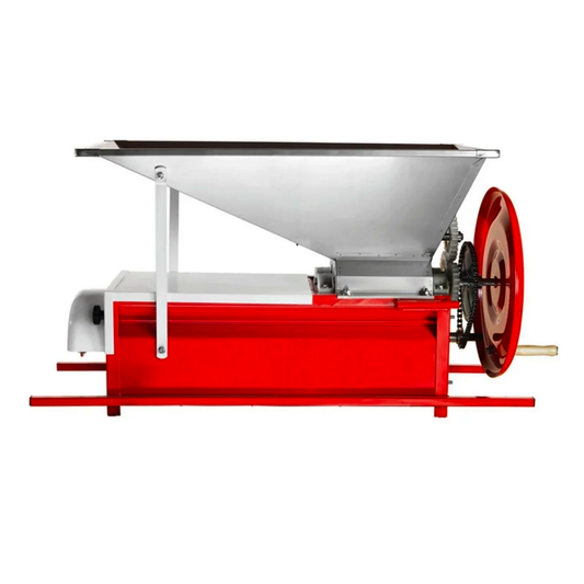 A red and silver manual  grape crusher destemmer with a large conical hopper on top, a red base frame, gears, and a red hand wheel on the right side, photographed on a plain white background