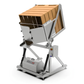A commercial industrial tipping bin with a silver metal frame, black hydraulic legs, and a wooden slatted hopper filled with brown cardboard boxes, shown on a white background.