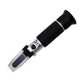 Refractometer with black handle and clear body on a white background