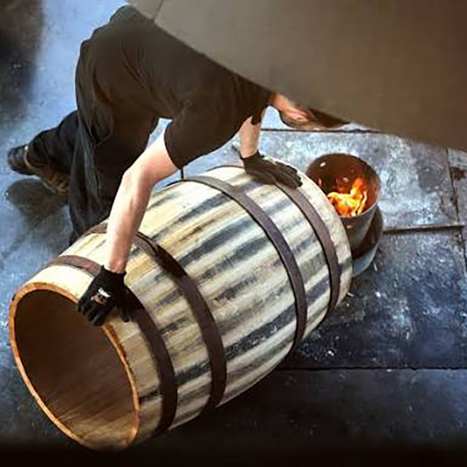 image of a wooden wine barrel being toasted