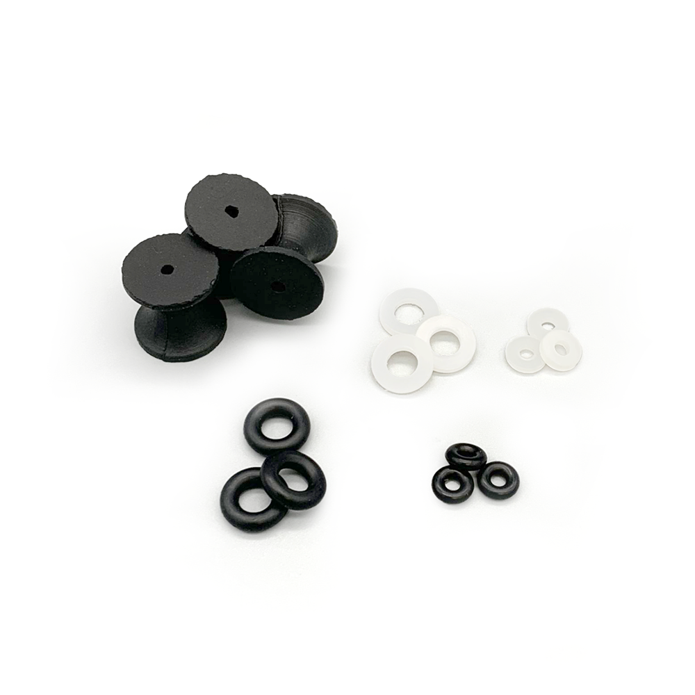 Black and white rubber gasket and washer components arranged on a plain white background.